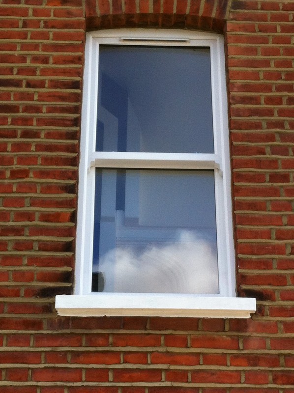 uPVC sash window on Victorian red brick house in East Dulwich